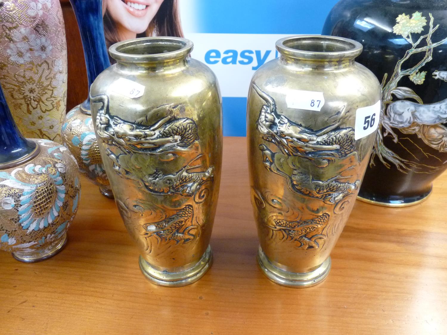 Pair of Chinese Brass vases with embossed Dragon decoration over stepped base, 21.5mc in Height