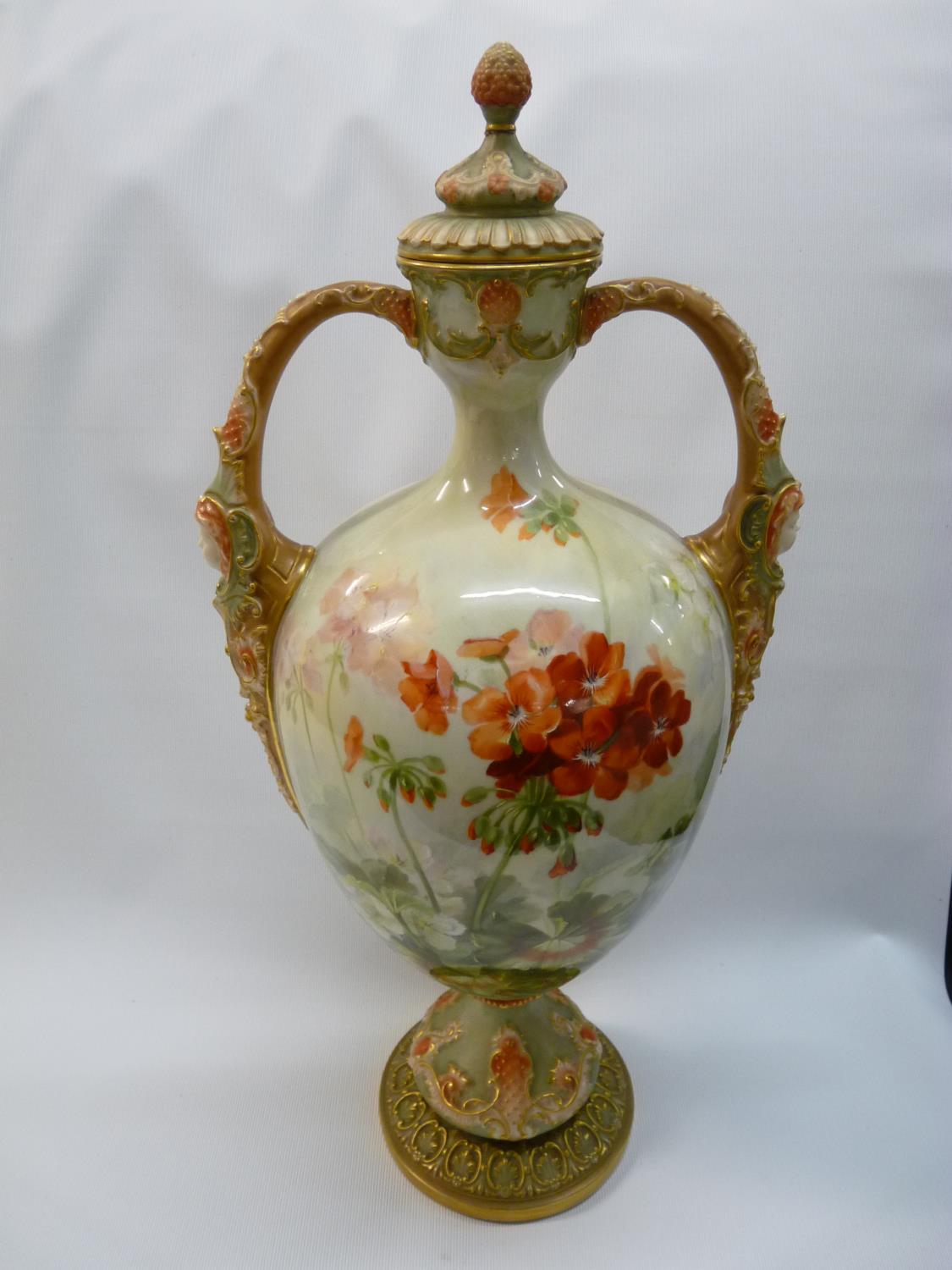 Large Royal Worcester two handled Geranium decorated vase by Frank Roberts with gilded mask handles,