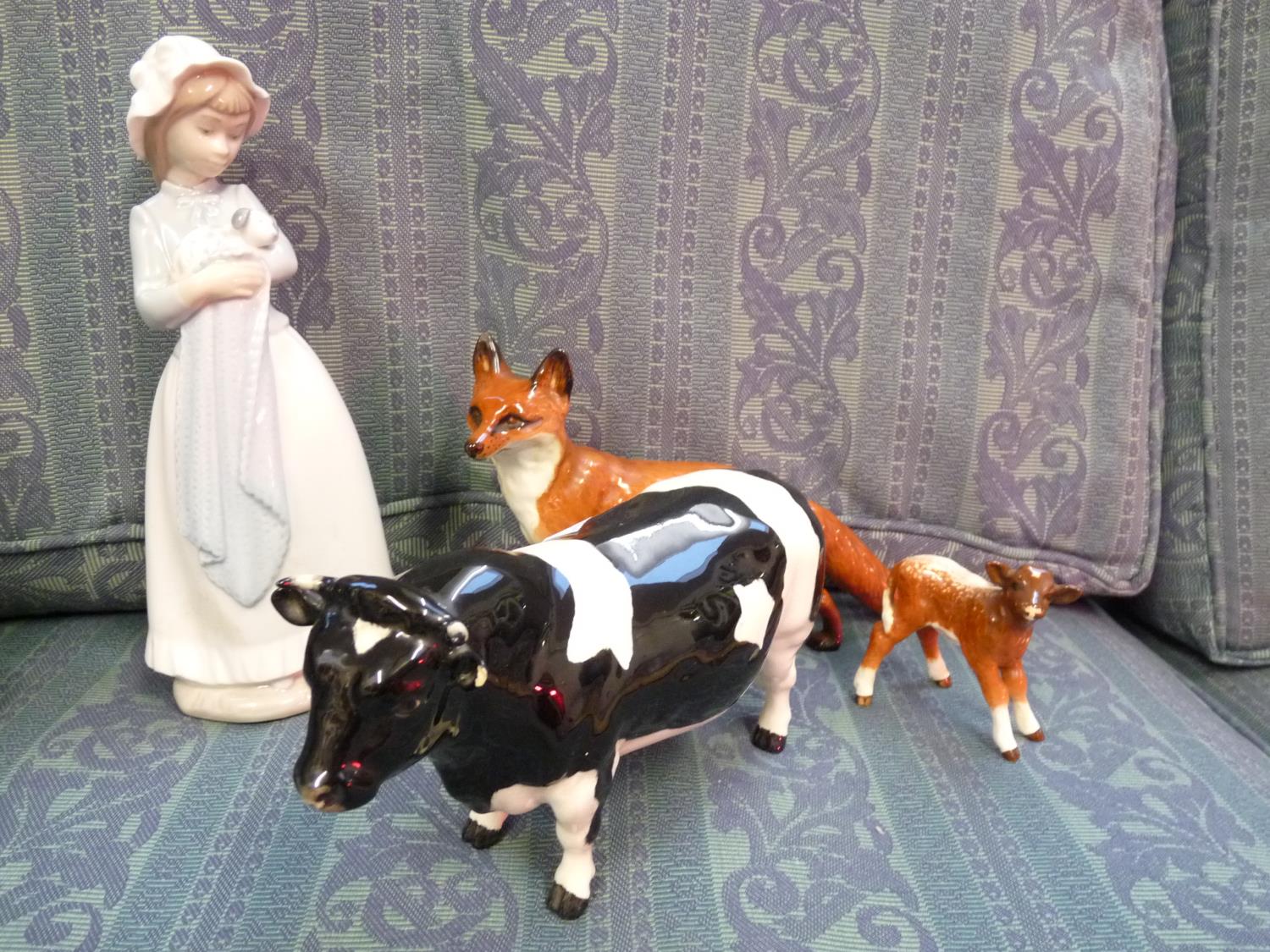 Beswick figure of a Fresian Bull, Beswick Calf in gloss, Beswick Fox and a Nao girl with puppy