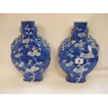 Pair of Chinese Qing Dynasty Blue and White Moonflasks with prunus decoration, twin dragon handles