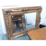 Large Ornate Gilt Gesso framed mirror with bevel edge