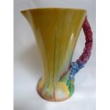 Bizarre by Clarice Cliff Wilkinson conical jug with floral handle and drip glaze, 22cm in Height