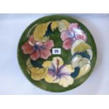 W Moorcroft bowl decorated with lilies on green ground, signed to base, with impressed mark and