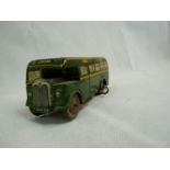 A Wells Brim Toy tin plate and clockwork Green Line bus comprising dark green with yellow trim,