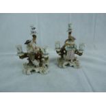 Pair of Sitzendorf figural candlesticks of two lovers with carrier pigeons on foliate naturalistic