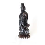 Qing Dynasty Red Carved Resin figure of Guan Yin in flowing robe, on Hardwood carved foliate base,