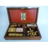 Edwardian Walnut cased Games compendium including De La Rue Playing cards, Bone Dominoes etc