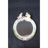 Good Quality Sitzendorf Oval wall mirror with surmounted Cherub decoration, beaded and floral frame,