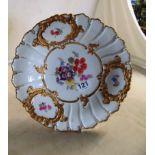 A Meissen plate with floral design and gilt embellishment.
