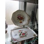 A 19th Century hand painted dish and a plated decorated Peacock