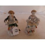 A pair of German porcelain figures girl and boy with lambs.