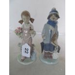 A Lladro figure boy dressed for winter with dog, and another girl with bird.