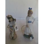 A Nao figure of girl playing cello and another girl with dog and hoop.