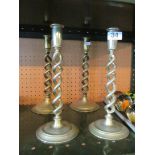 Two pairs of wrythen twist brass candlesticks