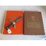 A German WW2 dagger, German book of cigarette cards on Adolf Hitler and another Deutschland