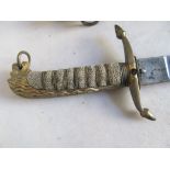 A 19th Century Naval sword with lion head and shagreen handle, engraved blade in leather scabbard.