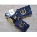 Two Concorde navy leather luggage labels