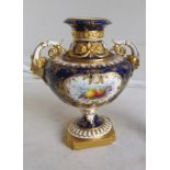 A Royal Worcester blue vase of fruit design, twin handles with gilt embellishments, leadless glaze.