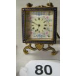 An enamel night clock with key.