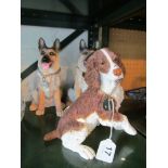 A Royal Doulton resin Spaniel and two Daschunds.