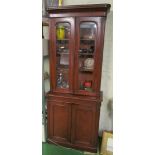 A small 19th Century mahogany bookcase with arched glazed doors above and cupboards