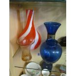 An orange swirl vase and three vases