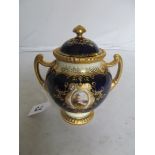 A Coalport blue and gilt lidded two handled vase C1910,hand painted Horam Castle (signed Eve