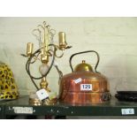 A copper kettle and onyx table lamp