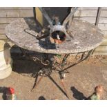 A concrete top garden table on metal base.