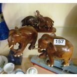 Three treen model elephants