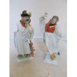 A pair of Herend porcelain figures gentlemen in female costume