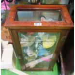 A small walnut and glass table top display cabinet with glass shelves