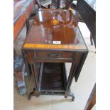 An Edwardian mahogany and satinwood dropleaf trolley with drawers and undertier on castors