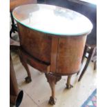 An oval walnut sewing table with hinged top and drawer on cabriole legs