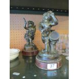 A pair of 19th Century French bronze cherubs one playing drum and carrying a pipe the other a