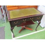 An Edwardian mahogany desk with green leather top, blind fret decoration on cabriole legs