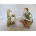 A pair of Royal Worcester kneeling Arab water carriers