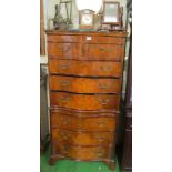 A 19th Century serpentine fronted chest with four long drawers, slide and three long drawers below