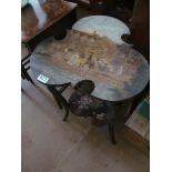 A painted trefoil shape table with Country house and two people on horseback, the lower shelf