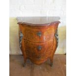 An 18th Century French bombe chest of three drawers with decoration of classical heads, caryatid