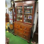 An oak chest of drawers surmounted with an early 19th Century mahogany two door cabinet