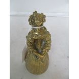 A brass bell in the form of a 17th Century lady