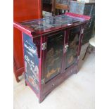 A Japanese lacquer cabinet with doors decorated scenes of figures