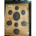 A set of eight black impressed plaques classical figures framed as one