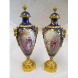 A pair of Sevres style urn shaped vases with reserves of courting couples and landscapes, blue and