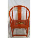 A red lacquer oriental chair with gilt decoration