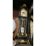 A reproduction miniature longcase clock and alarm clock.