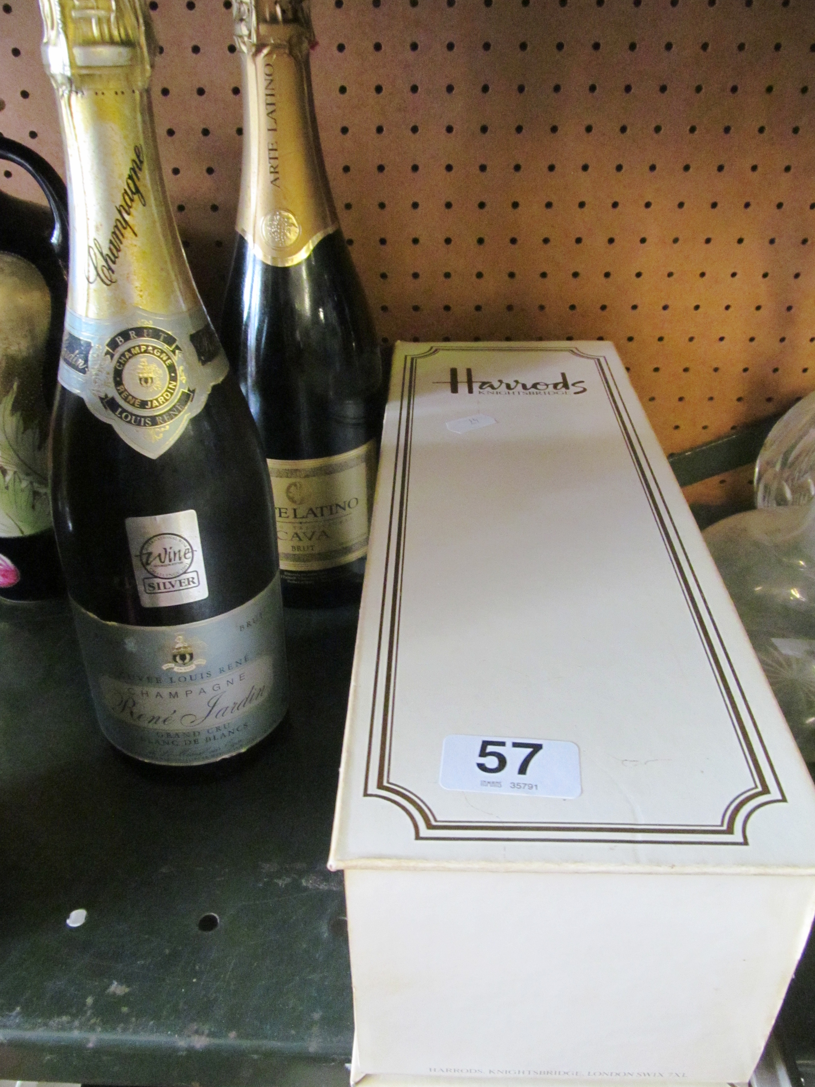 A bottle of Harrods champagne (boxed), bottle Rene Jardin champagne and a bottle of Carva.