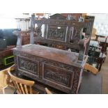 An oak bench with carved back