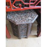 A carved octagonal table on carved ivy leaf stand